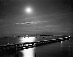 A night time photo of the single span Bridge.