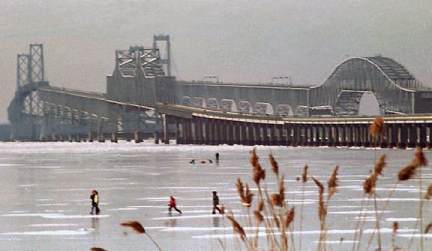 A photo of the frozen Bay with Bridge in background
